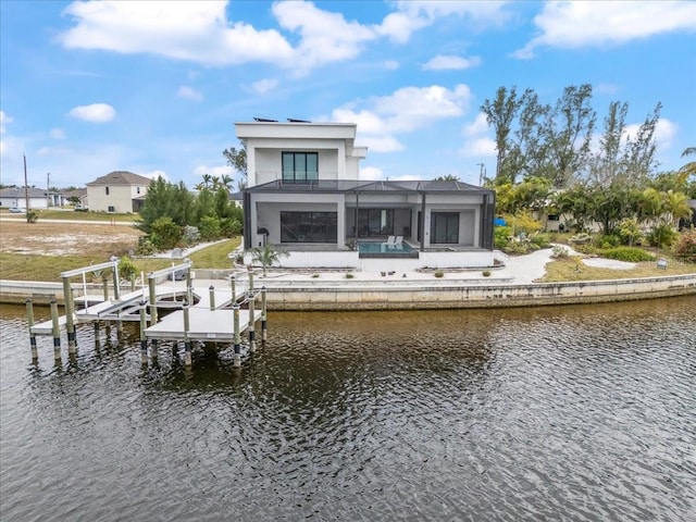 view of dock with a pool, a water view, and glass enclosure