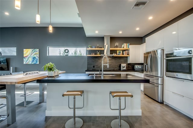 3715 NW 9th Ter, Cape Coral, FL 33993 - kitchen with stainless steel appliances, modern cabinets, wall chimney range hood, dark countertops, and decorative backsplash