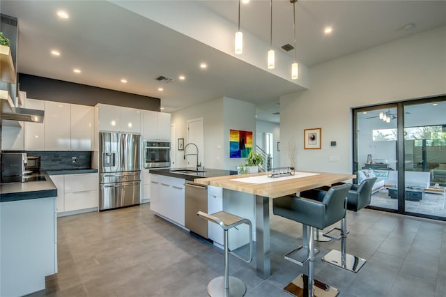 3715 NW 9th Ter, Cape Coral, FL 33993 - kitchen featuring stainless steel appliances, modern cabinets, a sink, white cabinets, and a center island with sink