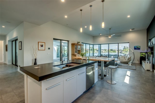 3715 NW 9th Ter, Cape Coral, FL 33993 - kitchen featuring a sink, dark countertops, open floor plan, ceiling fan, and stainless steel dishwasher