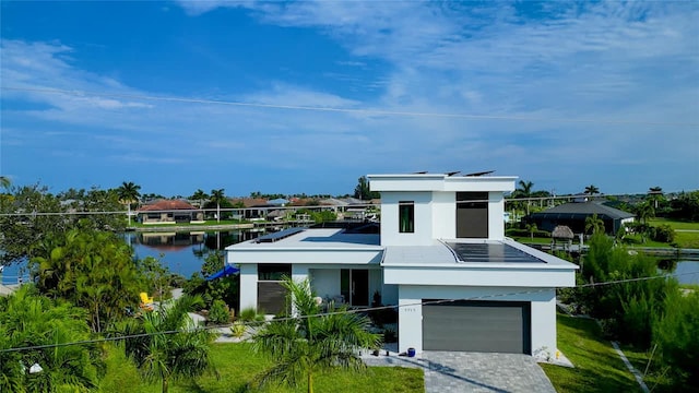 3715 NW 9th Ter, Cape Coral, FL 33993 - view of front of property with stucco siding, an attached garage, a water view, and driveway