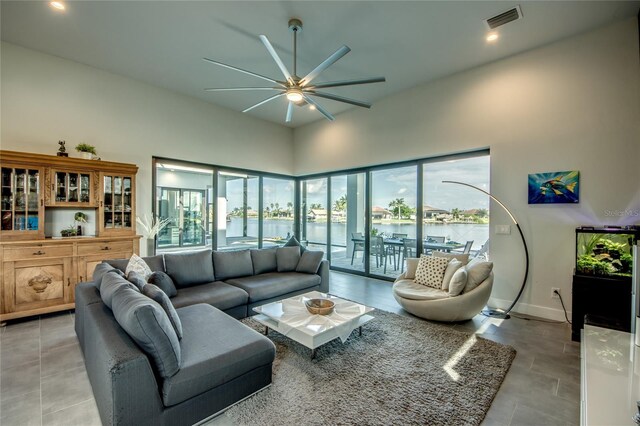 3715 NW 9th Ter, Cape Coral, FL 33993 - living room with a ceiling fan, recessed lighting, a water view, baseboards, and a high ceiling