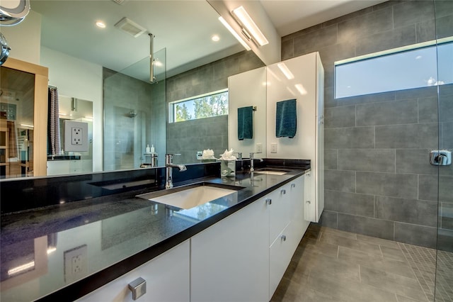 3715 NW 9th Ter, Cape Coral, FL 33993 - full bathroom featuring a tile shower, tile walls, double vanity, and tile patterned flooring