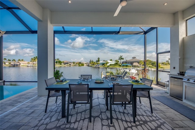 3715 NW 9th Ter, Cape Coral, FL 33993 - view of patio / terrace featuring a lanai, a water view, an outdoor kitchen, and a ceiling fan