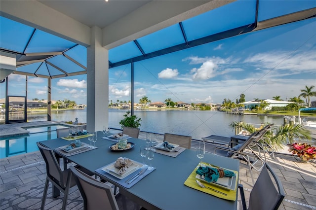 3715 NW 9th Ter, Cape Coral, FL 33993 - view of patio featuring a water view, an outdoor pool, a lanai, and outdoor dining area