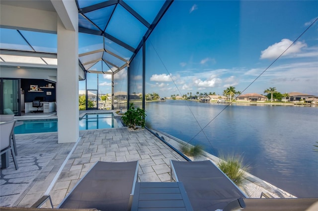 3715 NW 9th Ter, Cape Coral, FL 33993 - view of patio with glass enclosure, an outdoor pool, and a water view