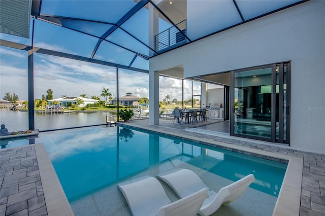 3715 NW 9th Ter, Cape Coral, FL 33993 - swimming pool featuring a water view, a patio area, glass enclosure, outdoor dining area, and area for grilling