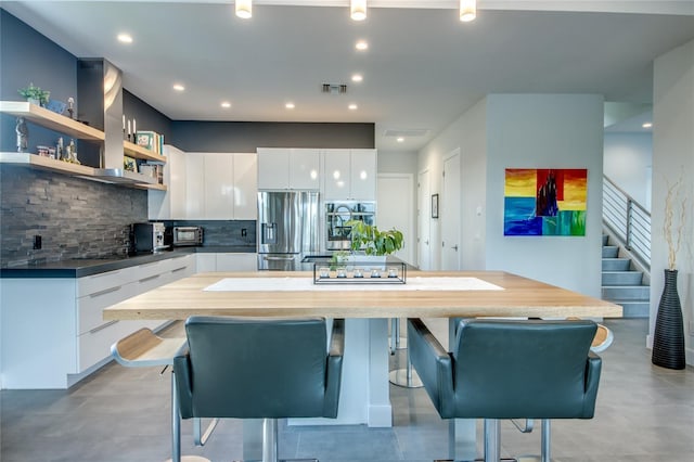 3715 NW 9th Ter, Cape Coral, FL 33993 - kitchen with appliances with stainless steel finishes, backsplash, white cabinetry, modern cabinets, and recessed lighting