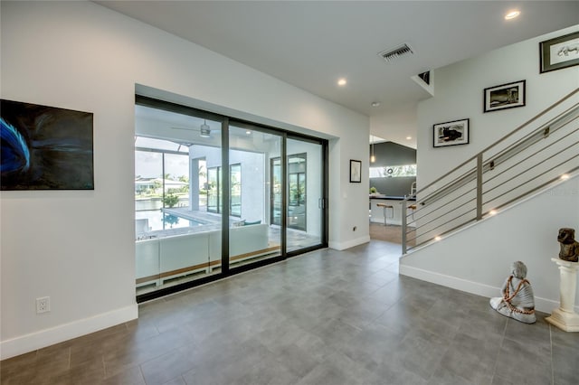 3715 NW 9th Ter, Cape Coral, FL 33993 - unfurnished living room with baseboards, stairway, and recessed lighting