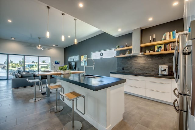 3715 NW 9th Ter, Cape Coral, FL 33993 - kitchen with dark countertops, freestanding refrigerator, modern cabinets, a sink, and decorative backsplash