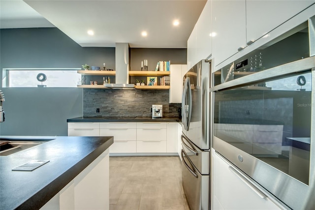 3715 NW 9th Ter, Cape Coral, FL 33993 - kitchen featuring dark countertops, modern cabinets, appliances with stainless steel finishes, a sink, and tasteful backsplash