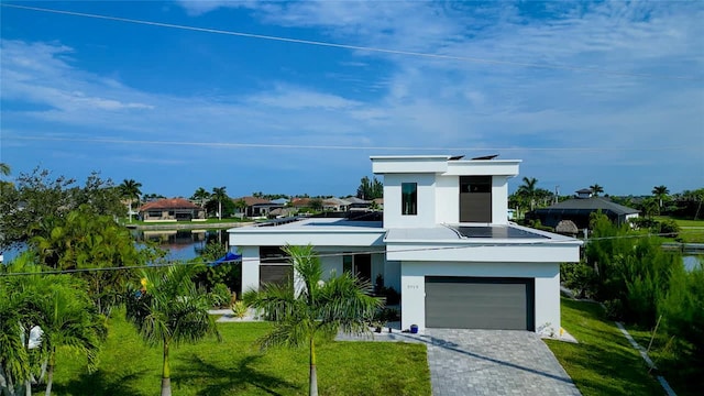 3715 NW 9th Ter, Cape Coral, FL 33993 - contemporary home featuring stucco siding, a front lawn, and decorative driveway
