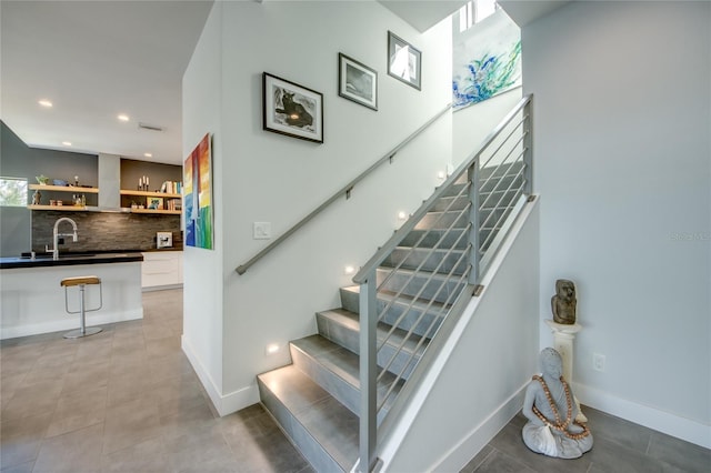 3715 NW 9th Ter, Cape Coral, FL 33993 - stairs featuring wet bar, recessed lighting, baseboards, and tile patterned floors