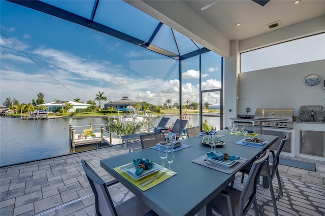 3715 NW 9th Ter, Cape Coral, FL 33993 - view of patio / terrace featuring exterior kitchen, outdoor dining space, a water view, a lanai, and a ceiling fan
