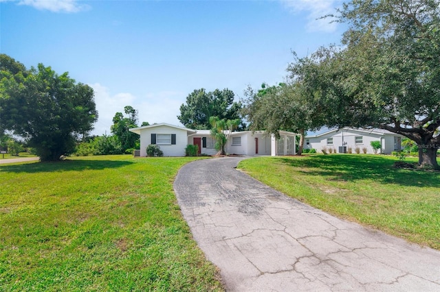 ranch-style house featuring a front lawn