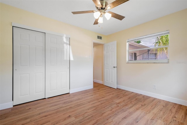 unfurnished bedroom featuring ceiling fan, a closet, and light hardwood / wood-style floors