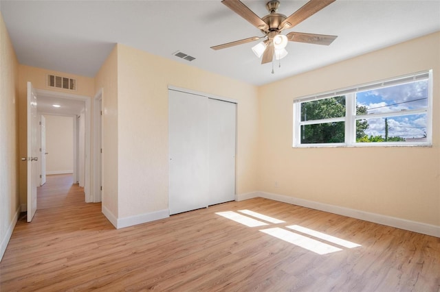 unfurnished bedroom with a closet, ceiling fan, and light hardwood / wood-style flooring