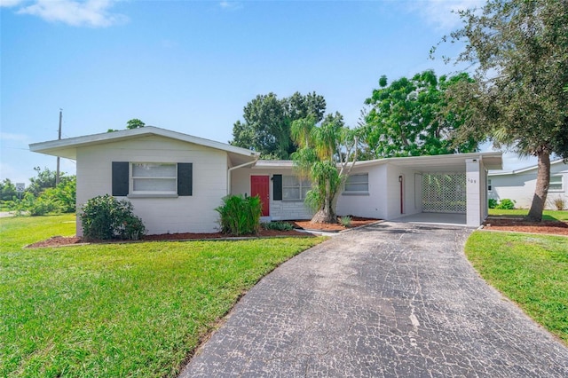 ranch-style home with a carport and a front yard