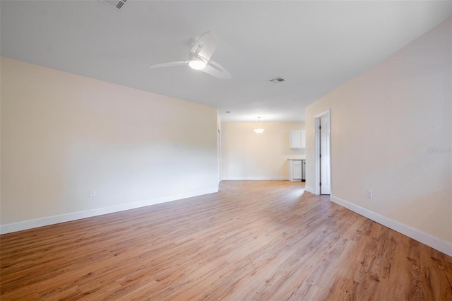 spare room featuring light hardwood / wood-style floors and ceiling fan