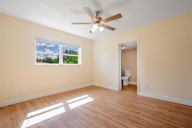 unfurnished bedroom with ceiling fan, light wood-type flooring, and ensuite bath