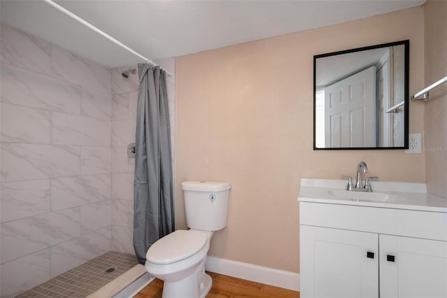 bathroom featuring a shower with curtain, toilet, vanity, and hardwood / wood-style flooring