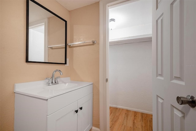 bathroom featuring vanity and hardwood / wood-style flooring