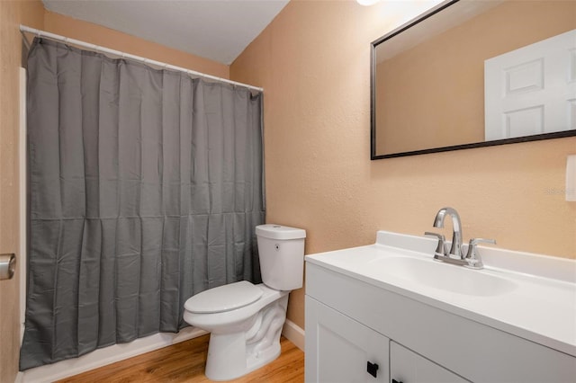 bathroom with vanity, hardwood / wood-style flooring, toilet, and curtained shower