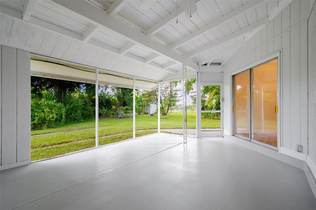 unfurnished sunroom with vaulted ceiling with beams