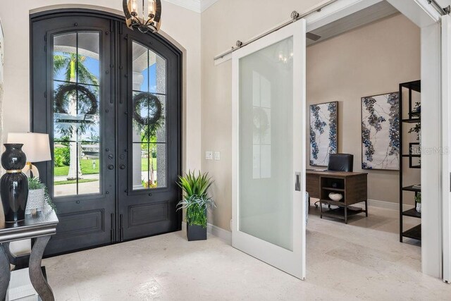 entrance foyer featuring crown molding, french doors, and a notable chandelier