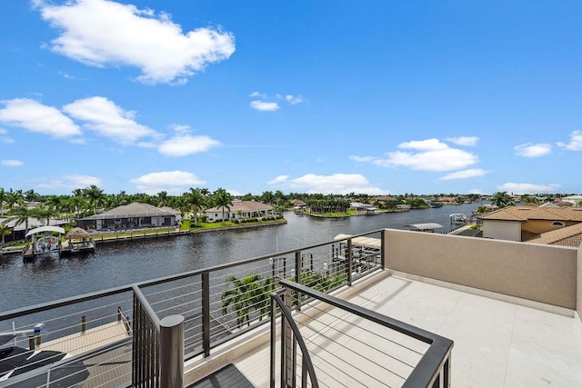 exterior space featuring a balcony and a water view