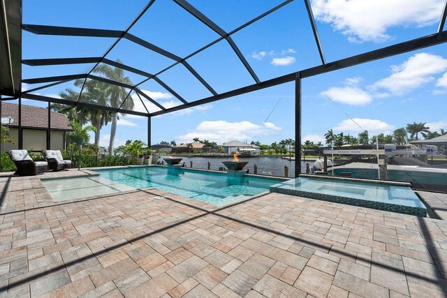 view of swimming pool with a water view, a lanai, an in ground hot tub, and a patio area