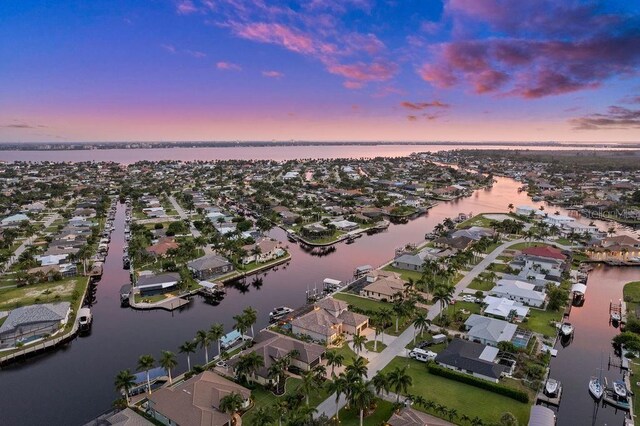 aerial view at dusk with a water view