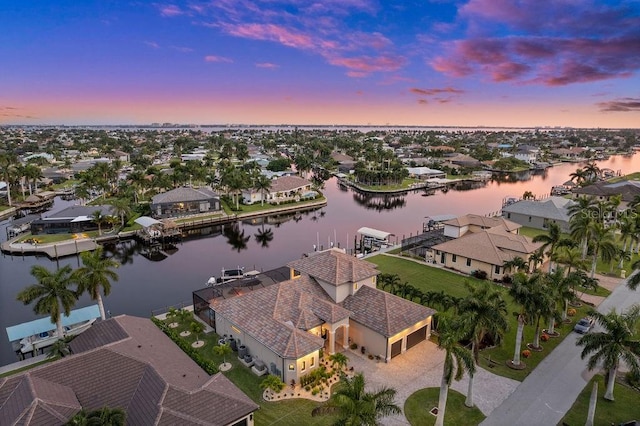 aerial view at dusk with a water view