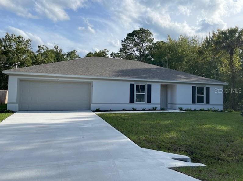 ranch-style home with a front lawn and a garage