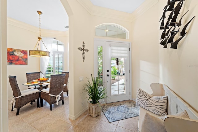 tiled foyer featuring plenty of natural light and ornamental molding