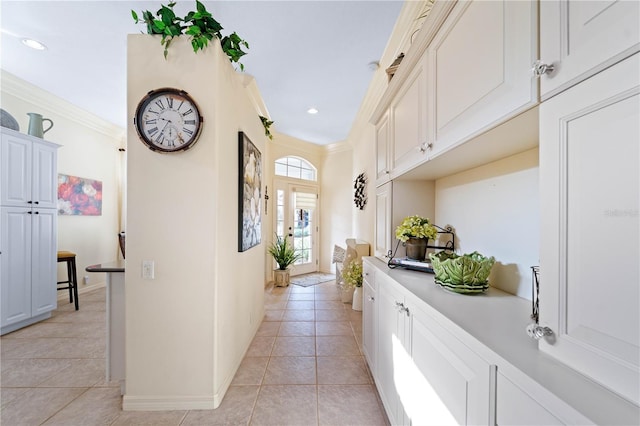 corridor featuring light tile patterned flooring and ornamental molding