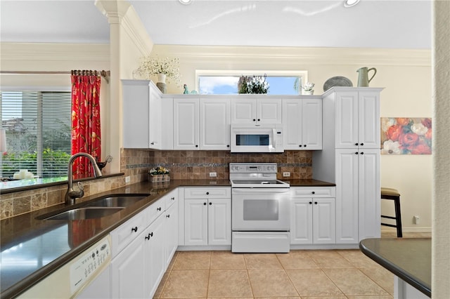 kitchen featuring sink, light tile patterned flooring, white appliances, white cabinets, and ornamental molding