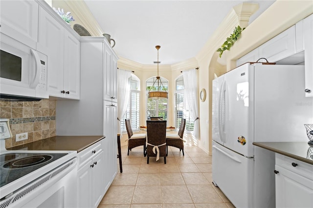 kitchen with white appliances, white cabinets, crown molding, tasteful backsplash, and decorative light fixtures