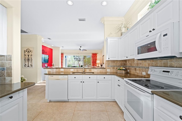 kitchen featuring white cabinets, crown molding, white appliances, and kitchen peninsula