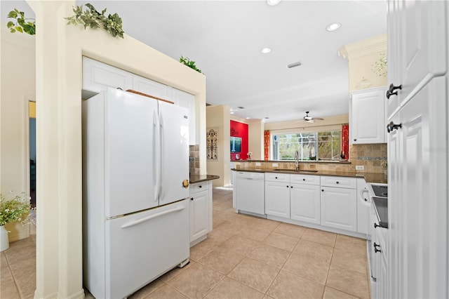 kitchen featuring decorative backsplash, white appliances, sink, white cabinets, and light tile patterned flooring