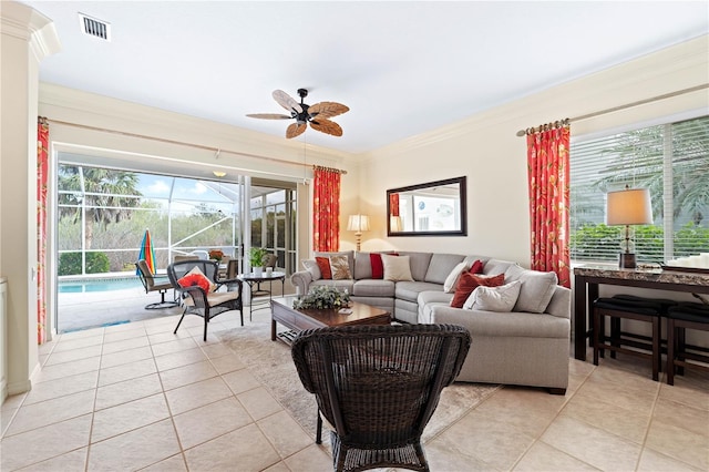 living room featuring ceiling fan, light tile patterned floors, and ornamental molding