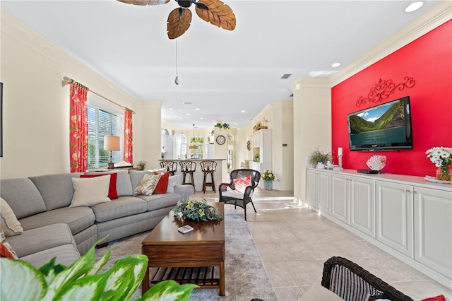 tiled living room featuring ceiling fan and ornamental molding