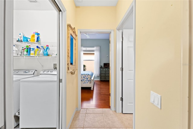 washroom featuring washing machine and dryer and light hardwood / wood-style floors