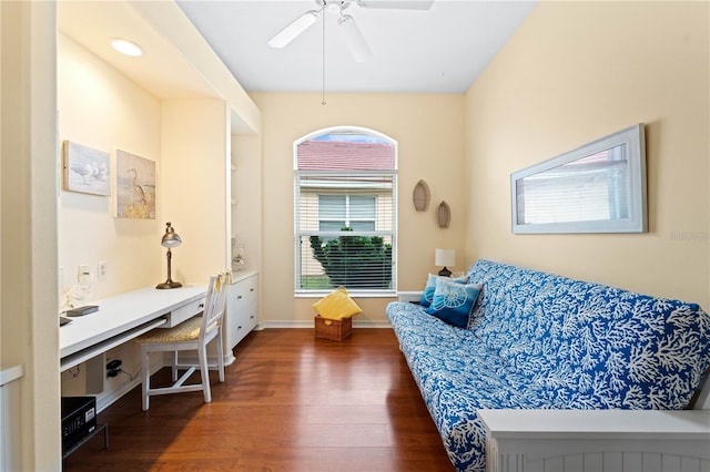 living area with dark hardwood / wood-style floors and ceiling fan