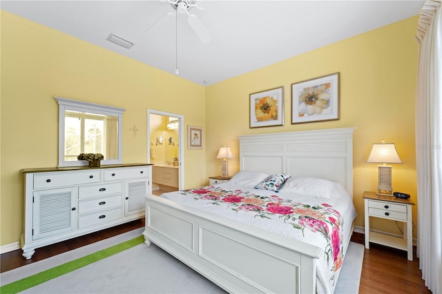 bedroom featuring connected bathroom, ceiling fan, and wood-type flooring