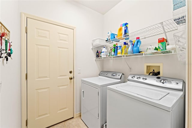 laundry area with light tile patterned flooring and washing machine and clothes dryer