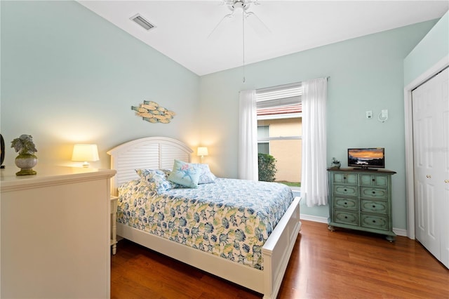 bedroom featuring ceiling fan, a closet, and hardwood / wood-style flooring