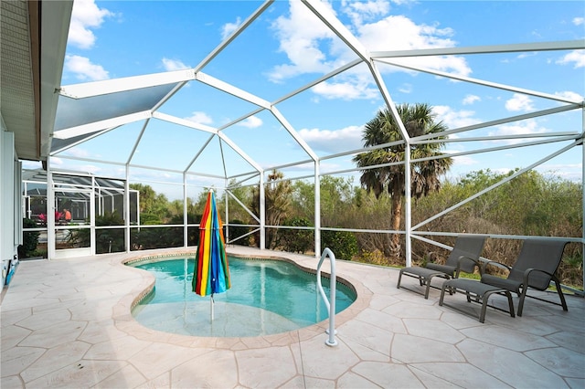 view of swimming pool with glass enclosure and a patio area