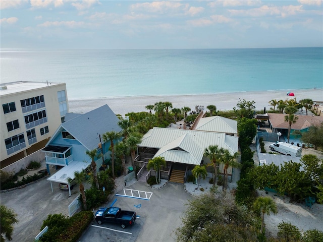 bird's eye view with a water view and a beach view