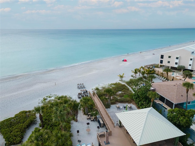 drone / aerial view with a water view and a view of the beach